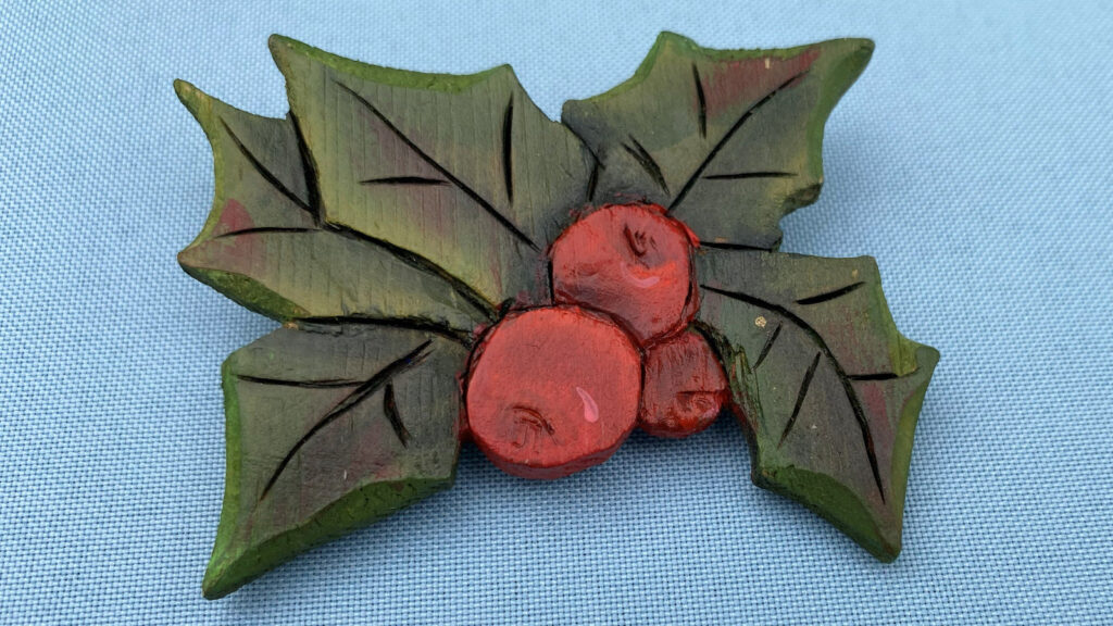 Holly branch ornament carved and painted by Rick and Gerry Jensen. It was donated to the club for the winter holiday party.