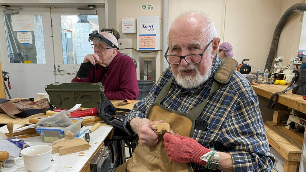 Dave is whittling a small bear from basswood.