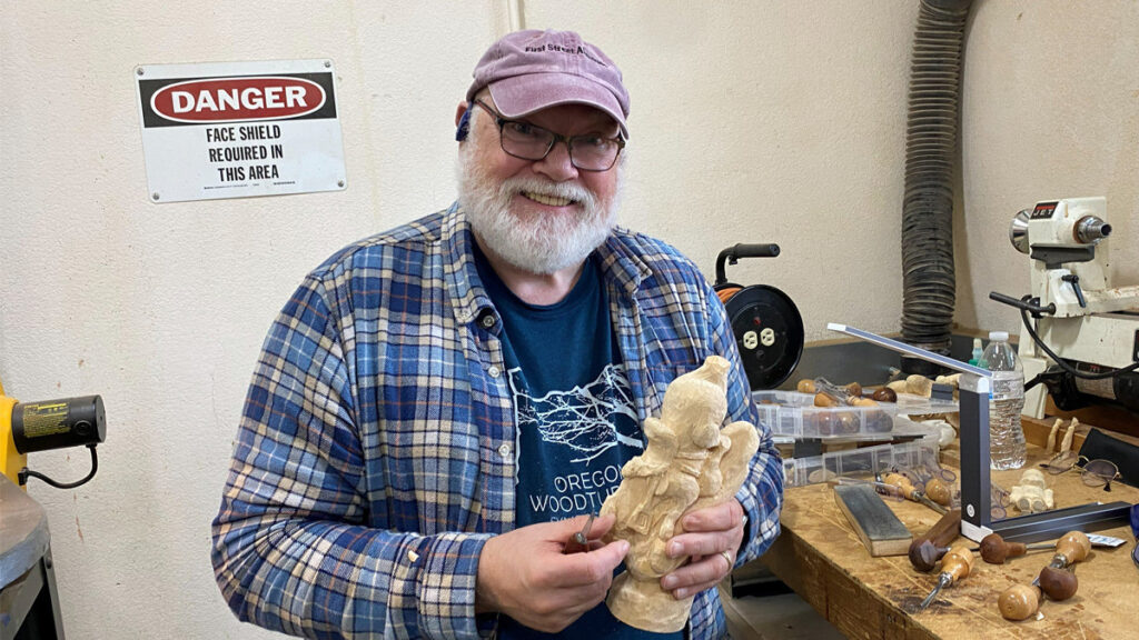 Lorin is carving a horse caricature.