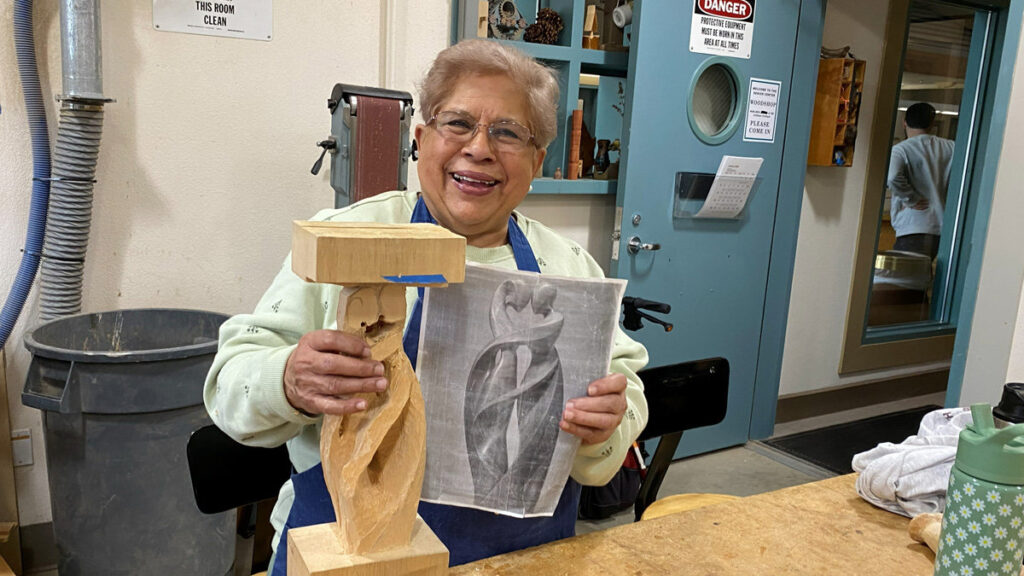 Maya is carving a stylized love sculpture.