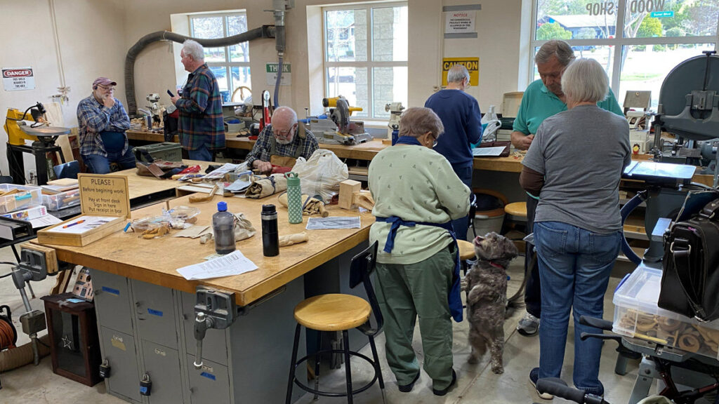 Wood shop at Pleasanton Senior Center. People are working on their woodcarving projects.